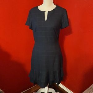 DARLING navy dress with a flirty skirt bottom!